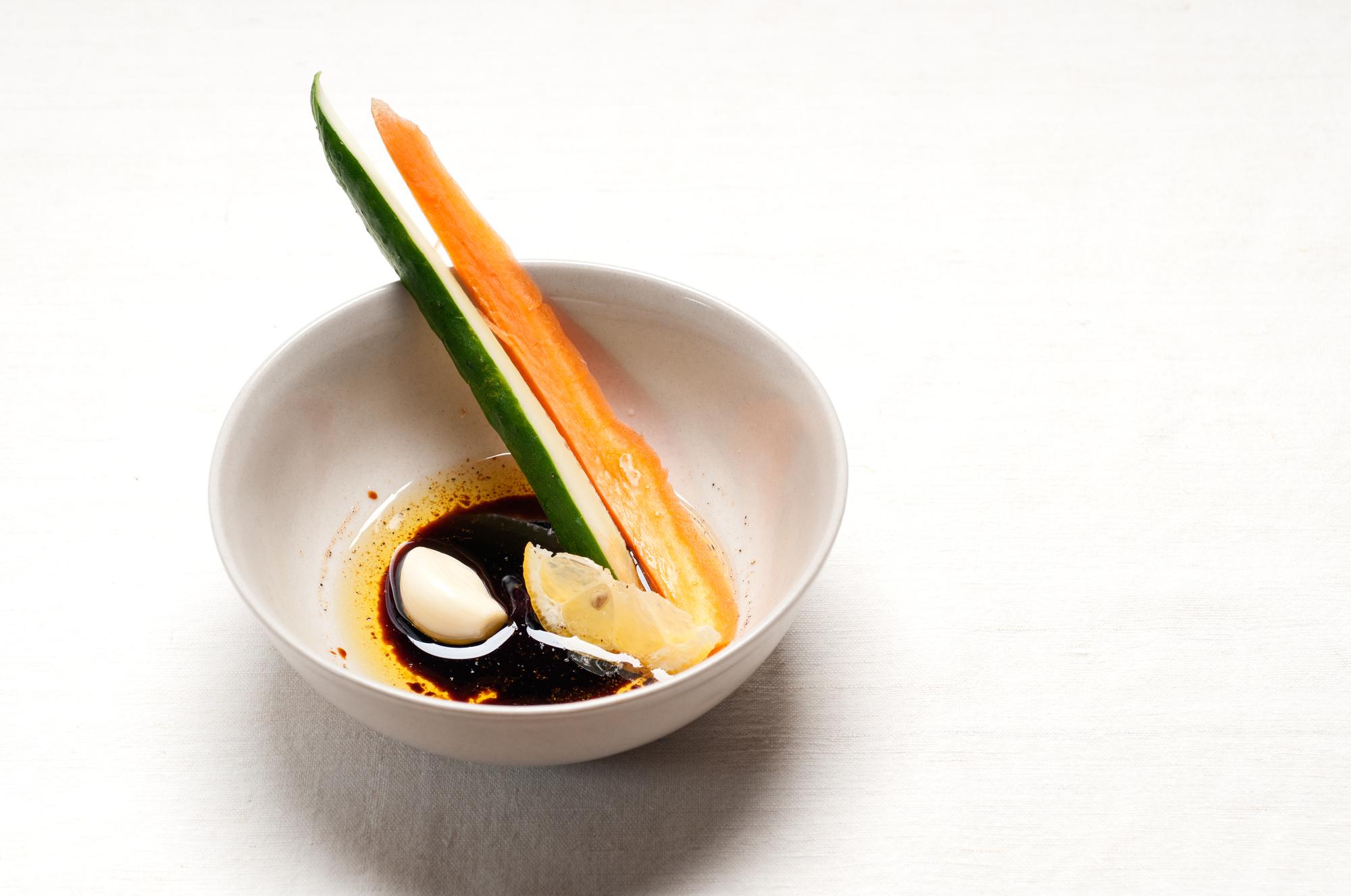 Close-up of plated experimental dish with sauce brush